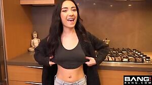 Showing her tiny boobs in the kitchen