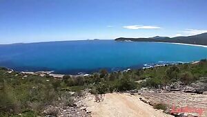 Making love by a beautiful landscape.