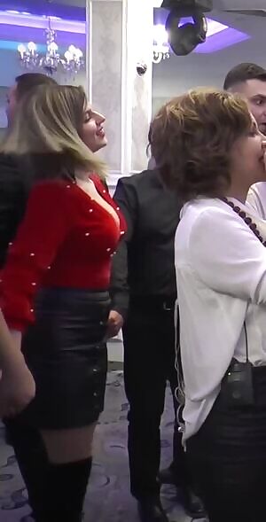 Busty girl dancing at romanian wedding