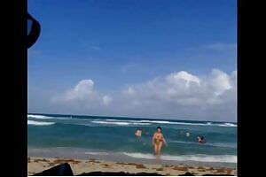 Sexy brunette goes naked from the sea