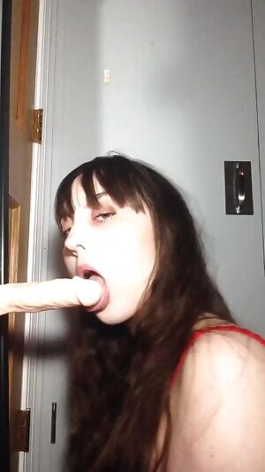 Practicing a blowjob on a dildo