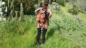 Strolling through the tall grass in her leather backpack
