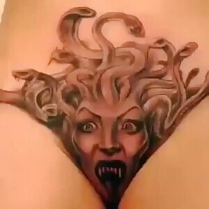 Medusa head on girl's, thankfully shaved, pubis and crotch