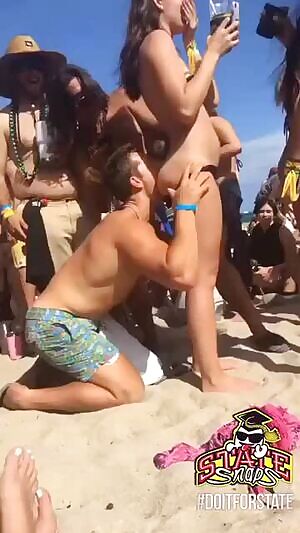 Guy eats girls ass on a crowded beach