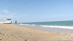 Erotic beach babe playing in the ocean