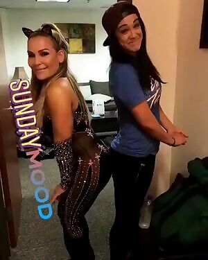 Natalya giving Bayley the rub she needs