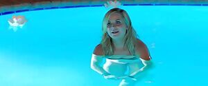 Amy Poeher in a pool wearing a bikini