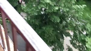 He fucks her on the balcony while people walk by below