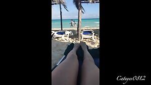 She fingers her pussy at the beach