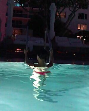 Serena Jung in a red bikini leaving the pool.