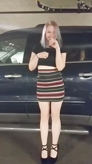 Pulling up her skirt in a parking garage