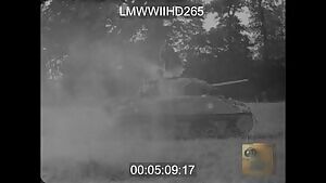 Free French soldiers remove the bodies of two crew members from a knocked out Sherman tank, August 1944