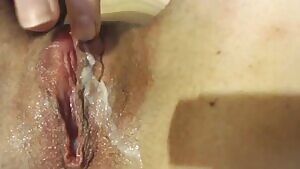 Squeezing out her cream