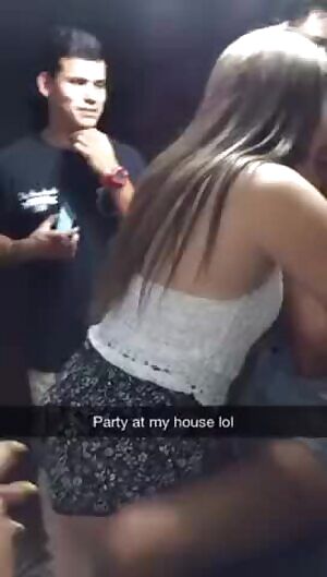 Passionate kiss at a party.