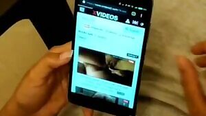 Jerking him while she watches porn.