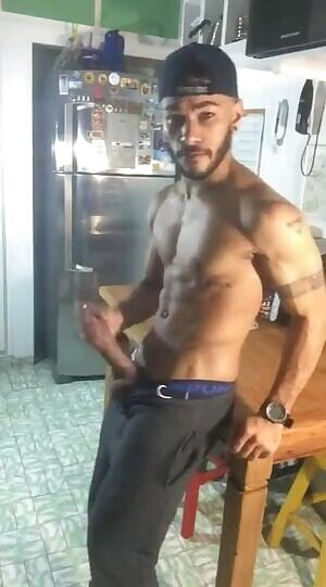 Beating his meat in the kitchen