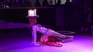 Balancing a tray of lit candles and belly dancing at the same time