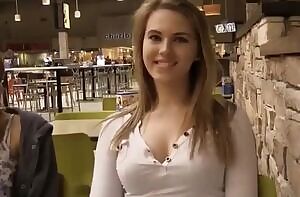 Adorable girl takes off her bra in a restaurant