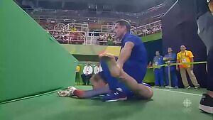 Gymnast Madison Kocian legs stretched by her trainer