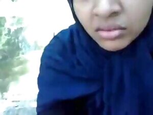 innocent girl reluctantly obeys her cousin, adjusts her hijab carefully after the act