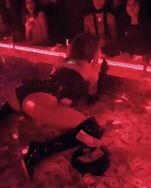 Halsey on stage at a strip club